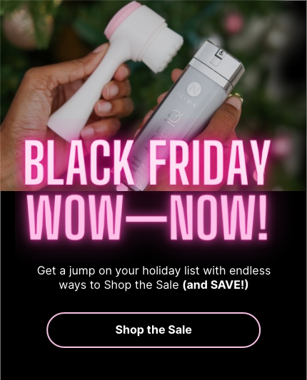 Black Friday Wow—Now! Woman holding Neora’s best-selling Age IQ Night Cream and a Dual-Action Facial Cleansing Brush